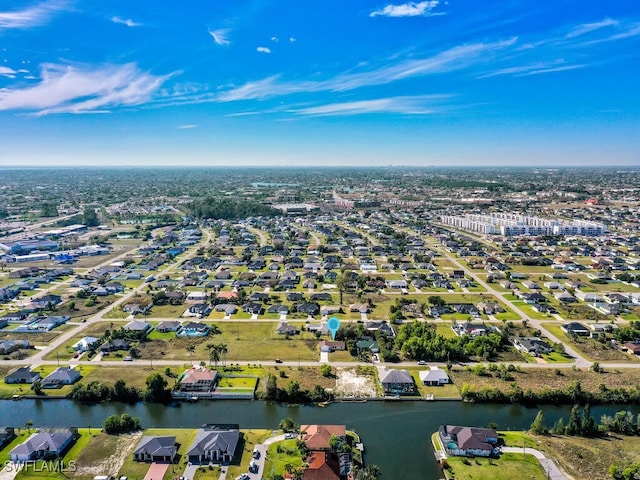 birds eye view of property featuring a water view and a residential view