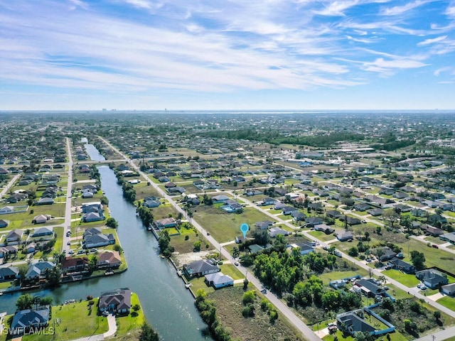 drone / aerial view with a water view and a residential view