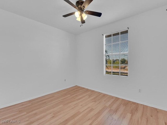 unfurnished room featuring wood finished floors and baseboards