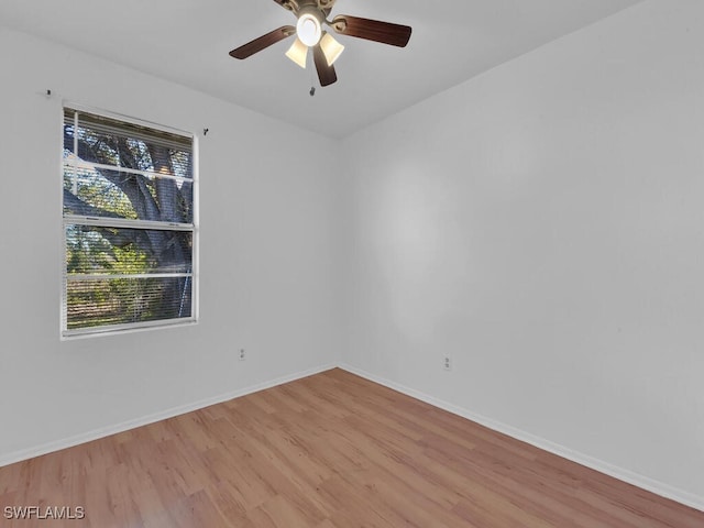 spare room with ceiling fan, baseboards, and light wood-style floors