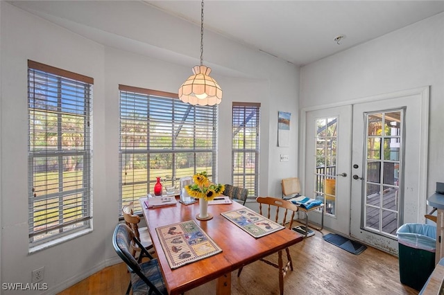 dining area with french doors and wood finished floors