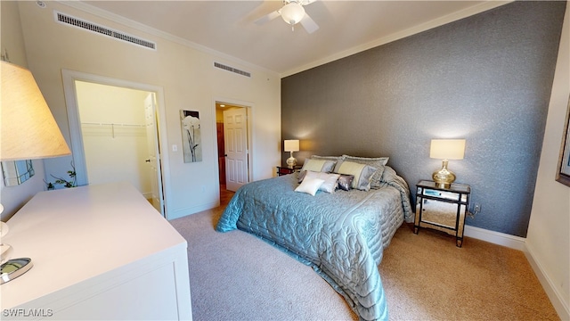 bedroom with baseboards, crown molding, visible vents, and carpet flooring