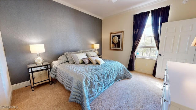 bedroom with a textured wall, light colored carpet, crown molding, and baseboards