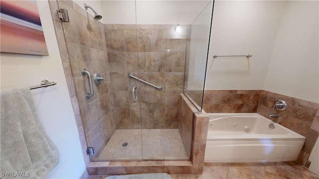 full bath featuring tile patterned flooring, a shower stall, and a tub with jets