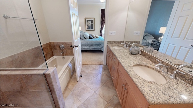 bathroom with double vanity, ornamental molding, ensuite bathroom, a sink, and a bath