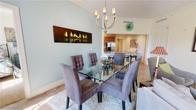 dining room featuring light tile patterned floors, baseboards, visible vents, crown molding, and a chandelier