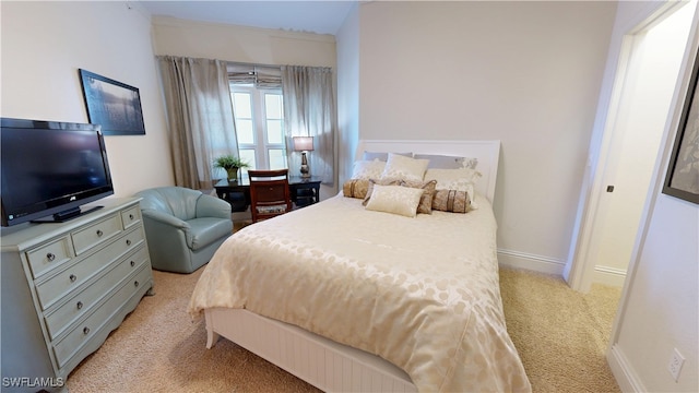 bedroom with light carpet and baseboards