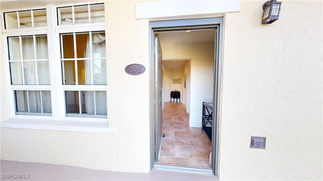 view of exterior entry featuring stucco siding