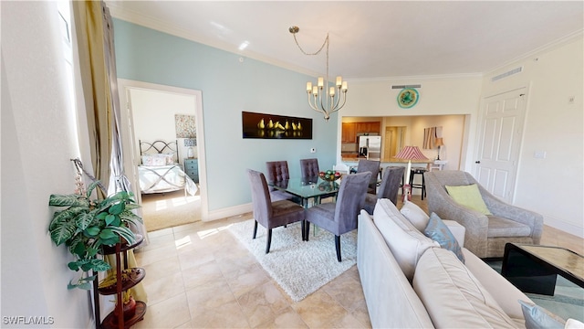 dining room with a chandelier, visible vents, ornamental molding, and baseboards