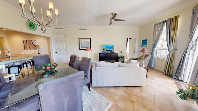 living room with ornamental molding, ceiling fan with notable chandelier, visible vents, and light tile patterned floors