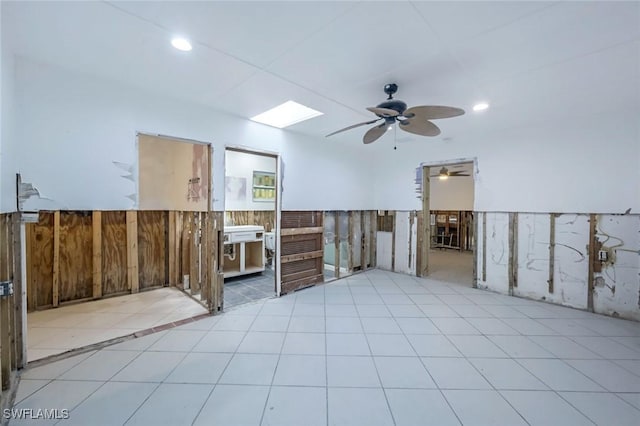 tiled spare room featuring a wainscoted wall, ceiling fan, wooden walls, and recessed lighting