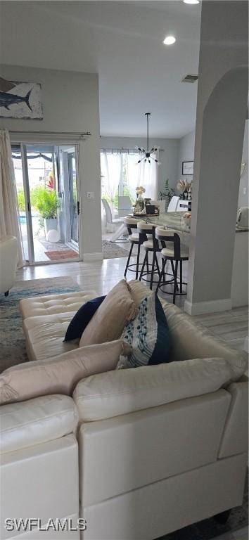 living room featuring baseboards and visible vents