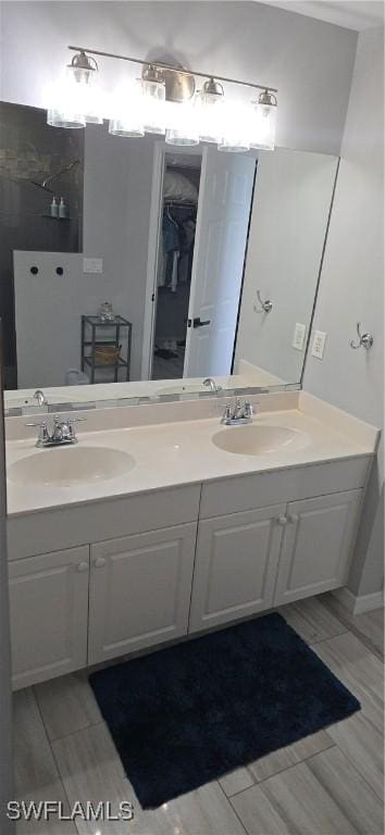 full bathroom with double vanity and a sink