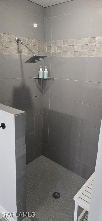 bathroom with tiled shower