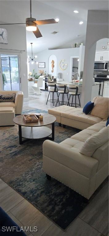 living area featuring recessed lighting, vaulted ceiling, and ceiling fan