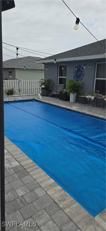 view of swimming pool with a fenced in pool, fence, and a patio