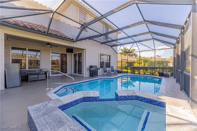 view of pool with a patio area, a pool with connected hot tub, ceiling fan, and area for grilling