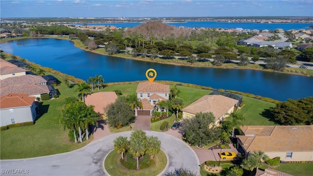 drone / aerial view with a water view and a residential view