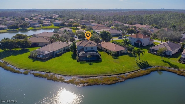 birds eye view of property with a water view and a residential view