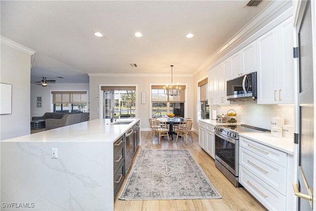 kitchen with stainless steel appliances, crown molding, light wood-type flooring, white cabinetry, and a sink