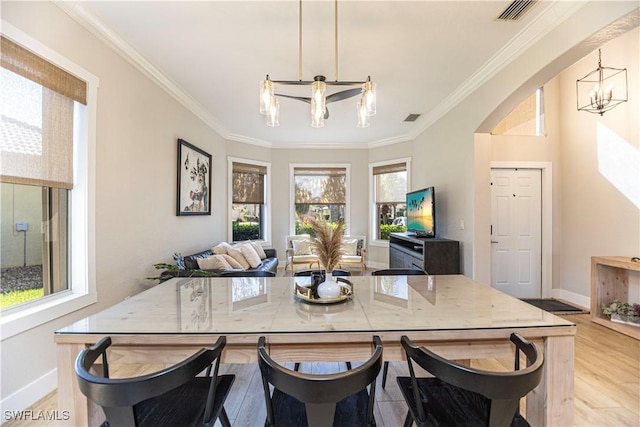 interior space with a chandelier, arched walkways, visible vents, and plenty of natural light