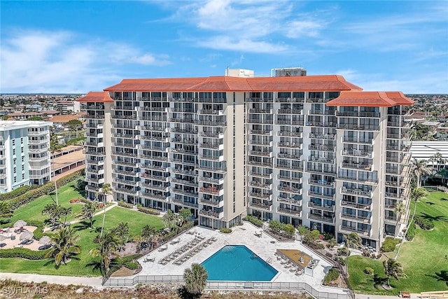 view of building exterior featuring a community pool