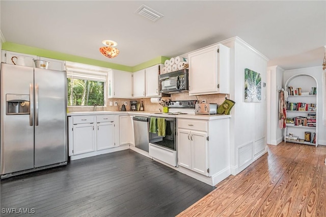 kitchen with visible vents, white cabinets, dark wood-style flooring, stainless steel appliances, and light countertops