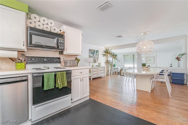 kitchen featuring white range with electric cooktop, light countertops, visible vents, black microwave, and dishwasher