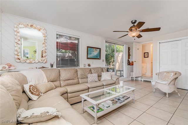 living area with ceiling fan and light tile patterned flooring