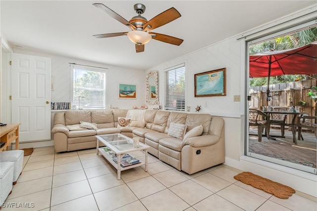 living room with a ceiling fan and light tile patterned floors