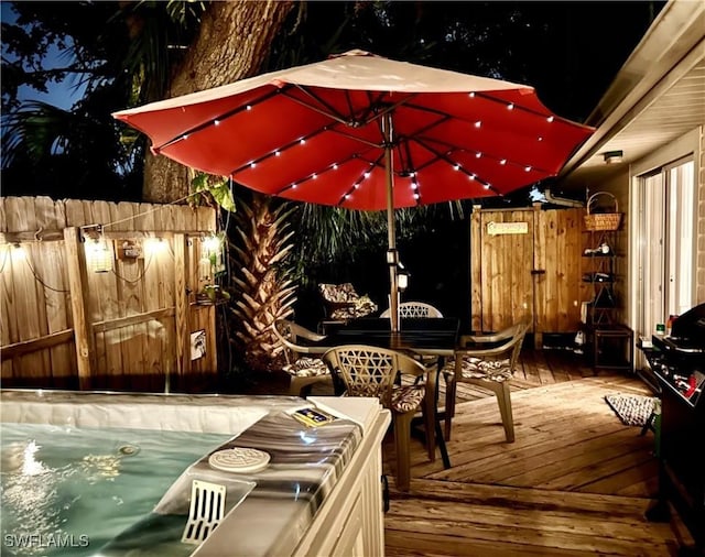 wooden terrace featuring outdoor dining area and fence