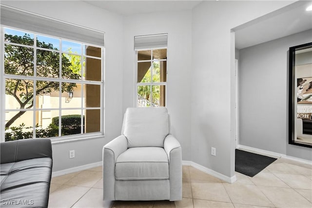 sitting room featuring tile patterned flooring and baseboards