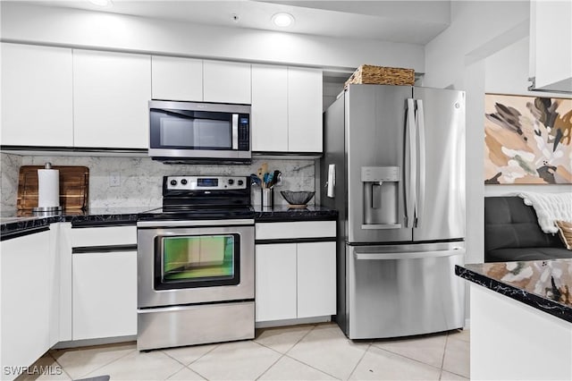 kitchen featuring white cabinetry, stainless steel appliances, and decorative backsplash