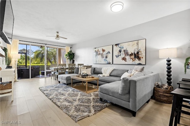 living room with a ceiling fan and wood finished floors