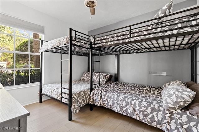 bedroom with ceiling fan and wood finished floors