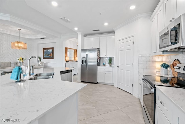 kitchen featuring visible vents, appliances with stainless steel finishes, crown molding, white cabinetry, and a sink