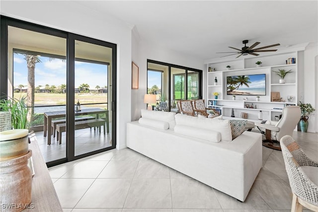 living area with a ceiling fan, light tile patterned flooring, and built in features