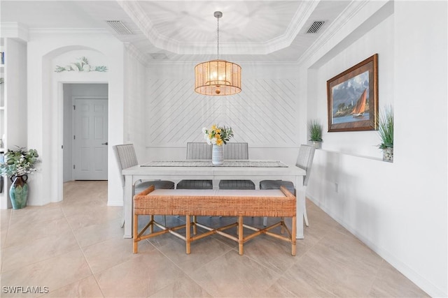 dining space featuring light tile patterned floors, a tray ceiling, visible vents, and crown molding