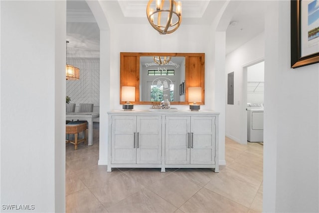 bar featuring washer / dryer, arched walkways, electric panel, and crown molding