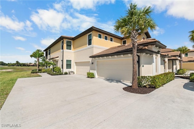 view of side of home with concrete driveway and stucco siding