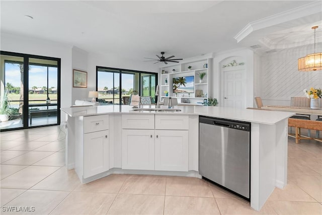 kitchen with light tile patterned floors, a sink, open floor plan, light countertops, and dishwasher