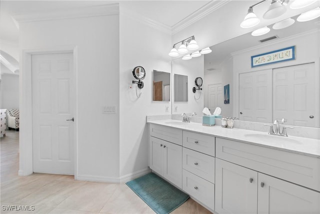 full bath with double vanity, ensuite bath, a sink, and crown molding