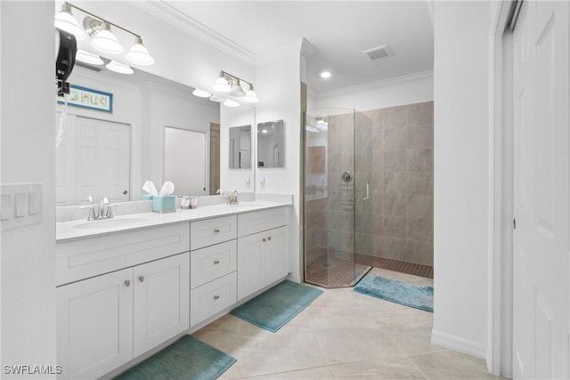 bathroom featuring a shower stall, a sink, visible vents, and crown molding