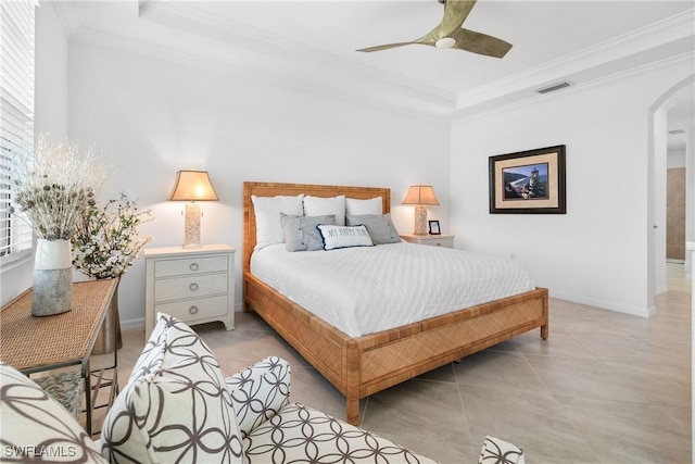 bedroom with visible vents, arched walkways, a raised ceiling, ornamental molding, and multiple windows