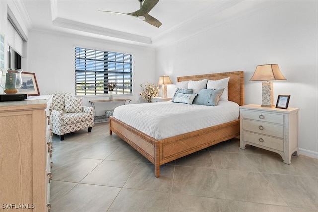 bedroom featuring ornamental molding, a ceiling fan, a raised ceiling, and light tile patterned floors