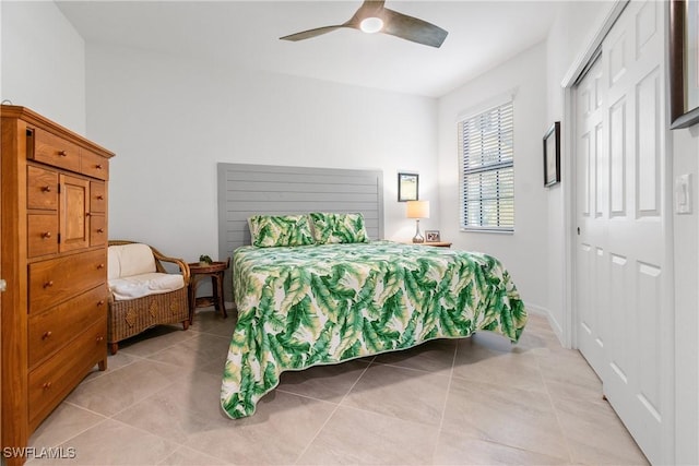 bedroom with ceiling fan, a closet, and light tile patterned flooring