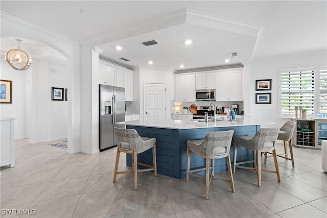 kitchen with appliances with stainless steel finishes, visible vents, and crown molding