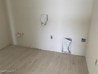 laundry room with wood finished floors