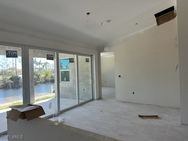 empty room with a healthy amount of sunlight and a water view