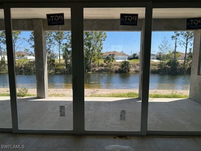 entryway with a water view and hardwood / wood-style flooring